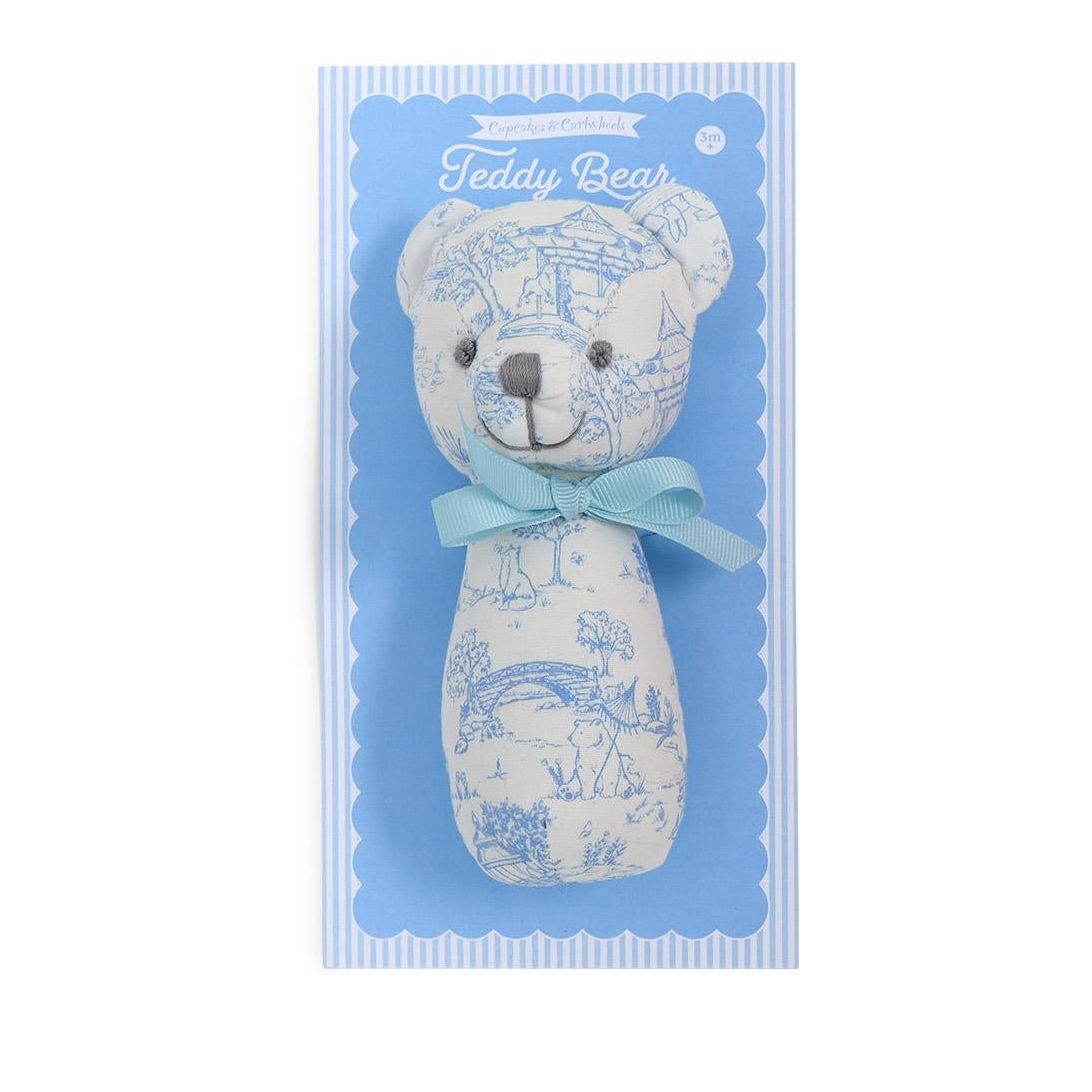 Two teddy bear rattles in packaging, one blue and one pink, on a white background.