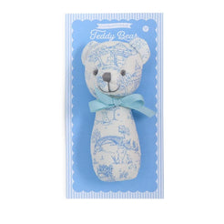 Two teddy bear rattles in packaging, one blue and one pink, on a white background.