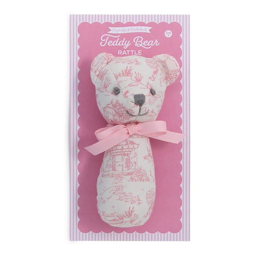 Two teddy bear rattles in packaging, one blue and one pink, on a white background.