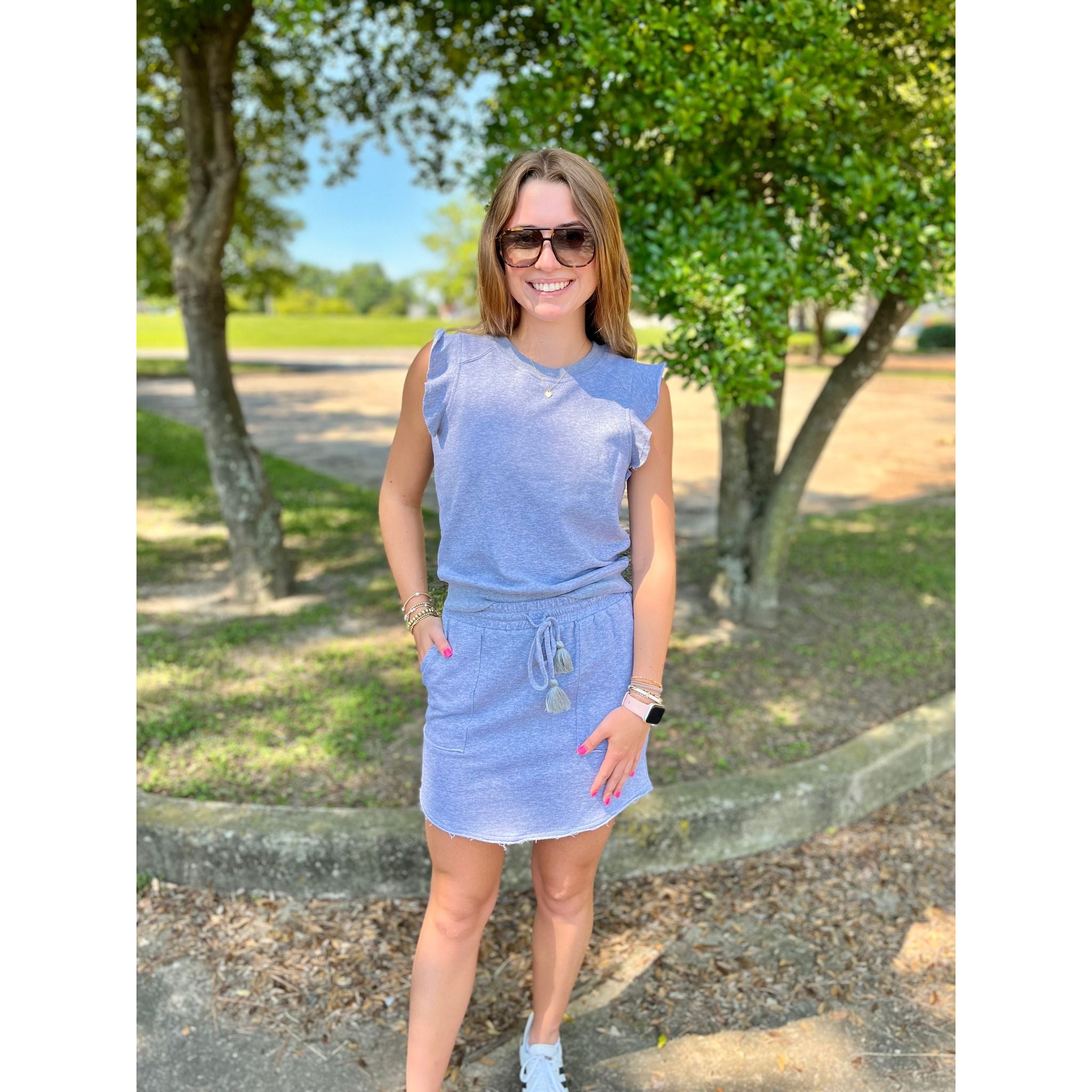 Get ready to elevate your wardrobe with the Beckham Skirt! This classic grey skirt boasts a drawstring waist for the perfect fit, and it even has a matching top for a complete and effortless look. Upgrade your style with the Beckham Skirt now!  Molly is wearing a size small.