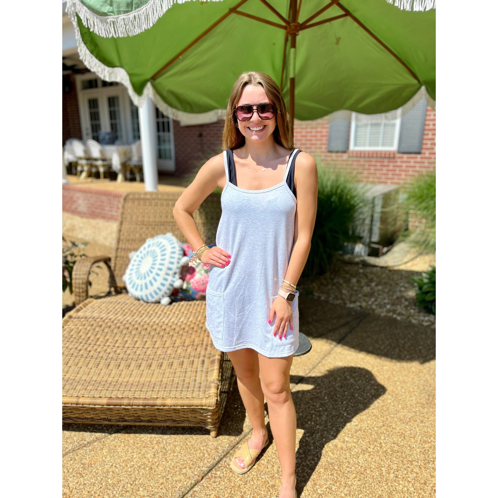 This sleeveless Amika Dress is more than just a cover up - it's a versatile and stylish addition to your wardrobe. Made from heather grey fabric, it's perfect for throwing on over your swimsuit and heading to the beach. Stay comfortable and chic all summer long!  Molly is wearing a size small.