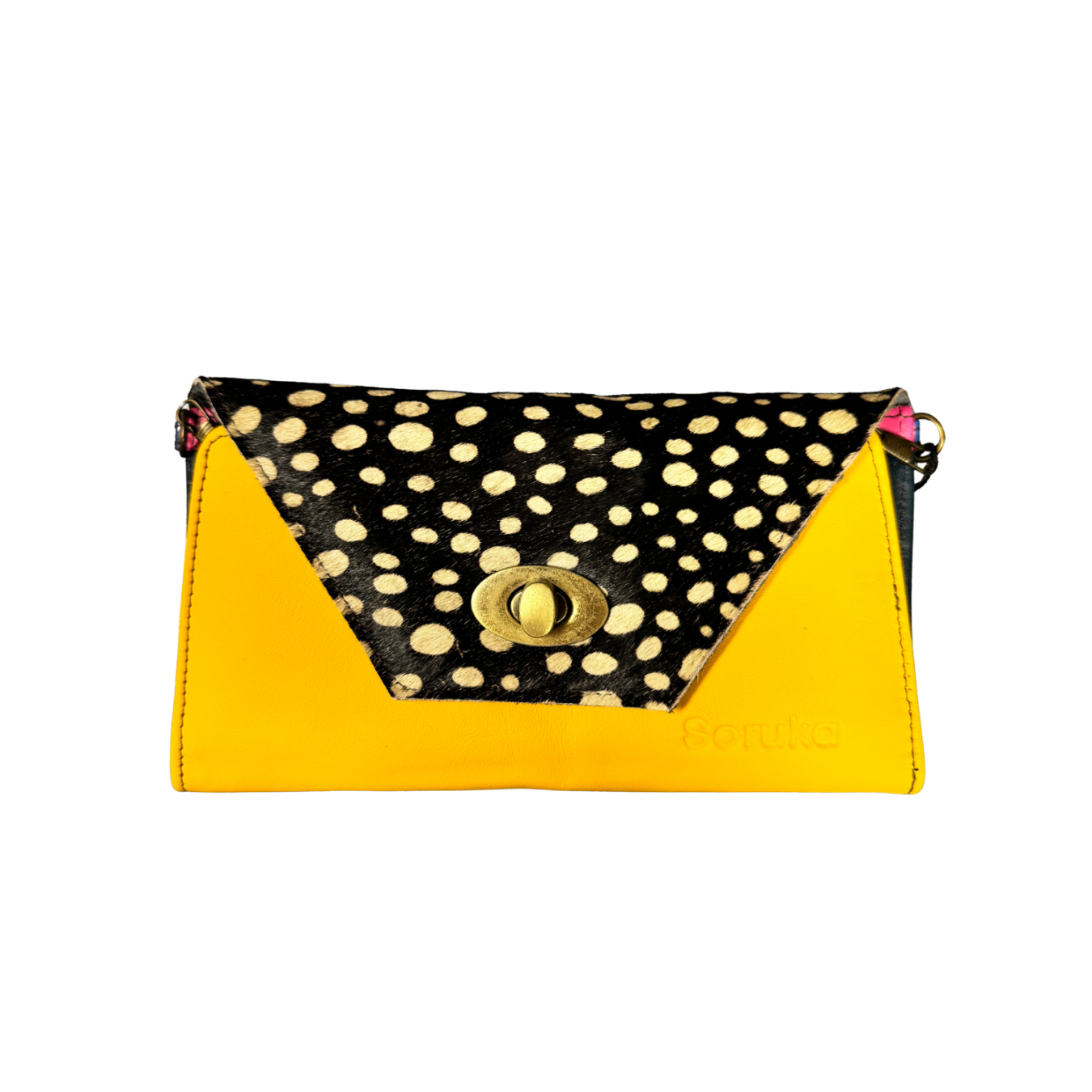 A color-blocked clutch bag with a bright yellow front and sides, a black flap decorated with beige cowrie shells, and a gold-tone turn-lock closure.