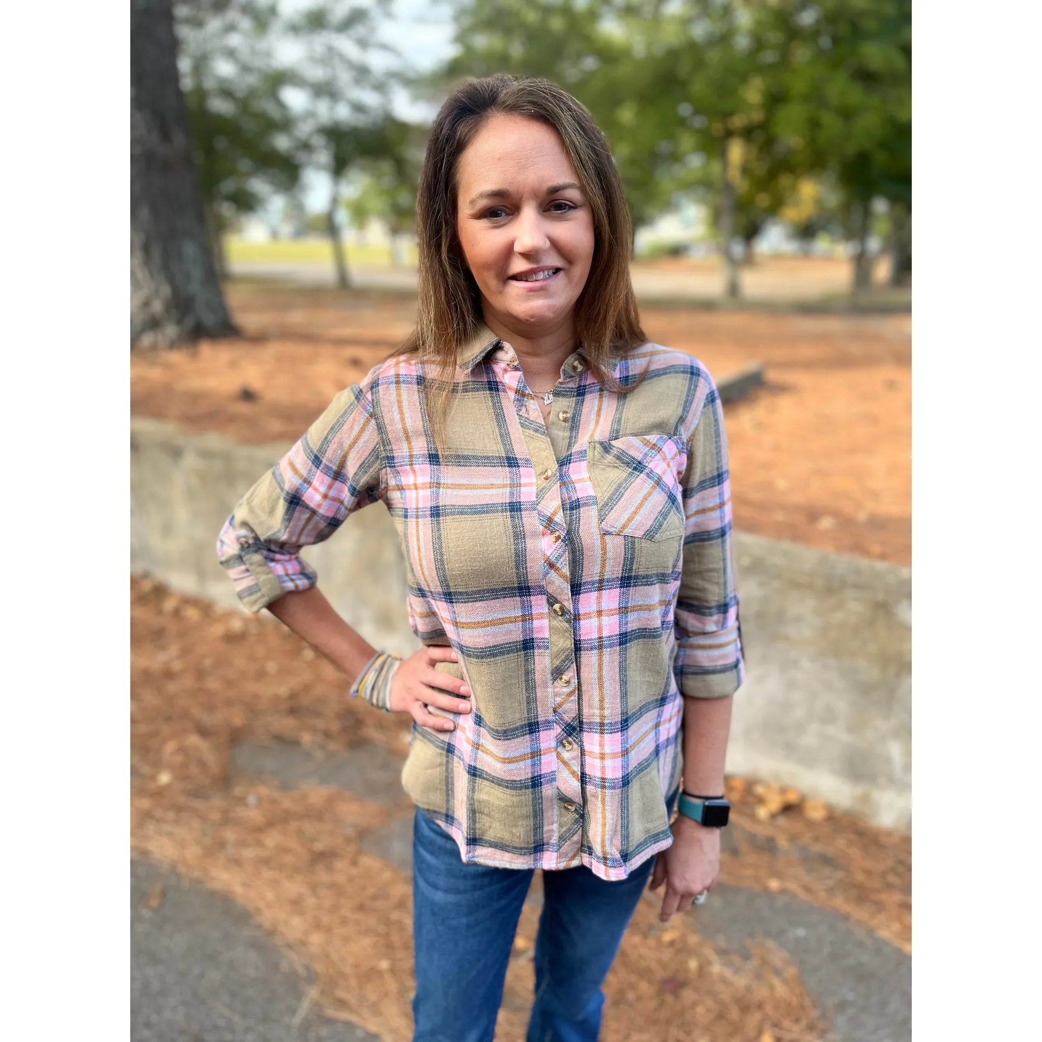 Stay cozy and stylish in our Emberly Shirt! This bright pink and green plaid is ideal for those chilly days spent camping or exploring. Complete with a button-down design, this shirt will keep you warm and comfortable while looking great.  Olivia is wearing a size small. 