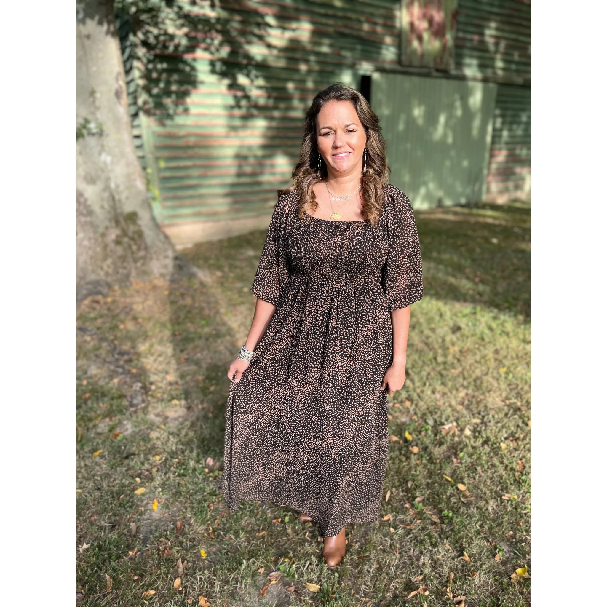 Say "hello" to the Maddie Raye Dress! This stunning maxi dress features a 2-tone shirred bodice that's sure to make a statement. It's black with a beautiful brown pattern for a look that's classic yet unique. Plus, the comfortable fit will have you looking and feeling like royalty!  Olivia is wearing a size small.