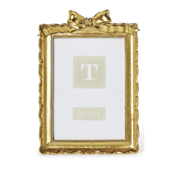 Two gold picture frames with decorative bows on a white background