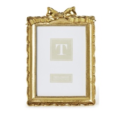 Two gold picture frames with decorative bows on a white background