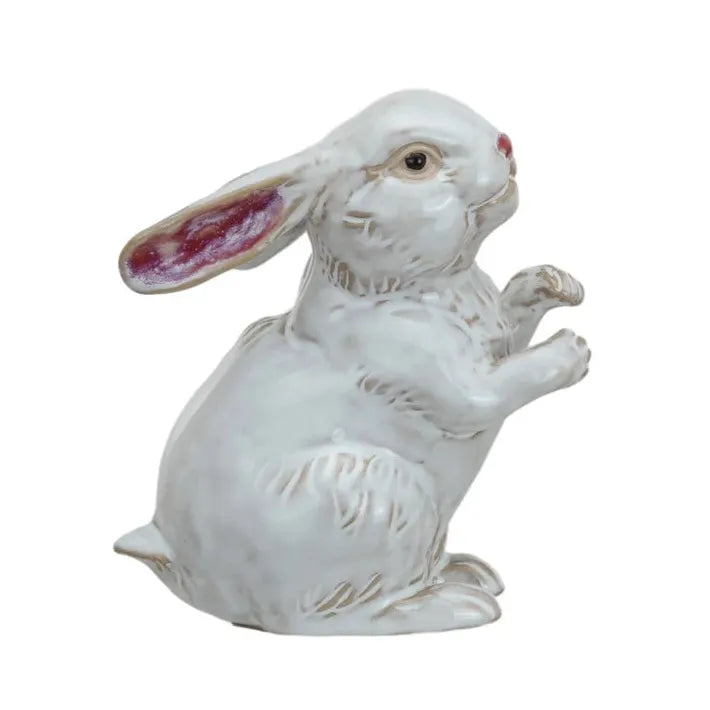 Two white ceramic rabbit figurines on a white background