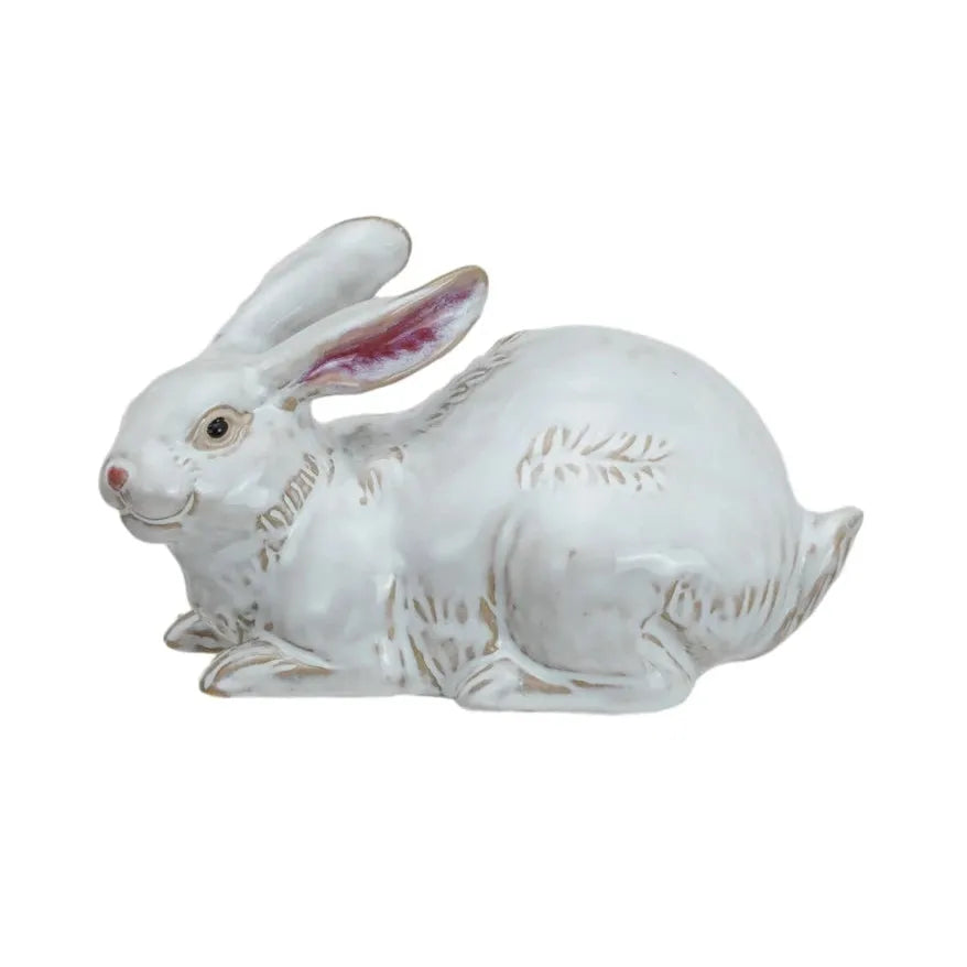 Two white ceramic rabbit figurines on a white background