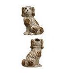 Set of four ceramic dog-shaped candle holders on a white background