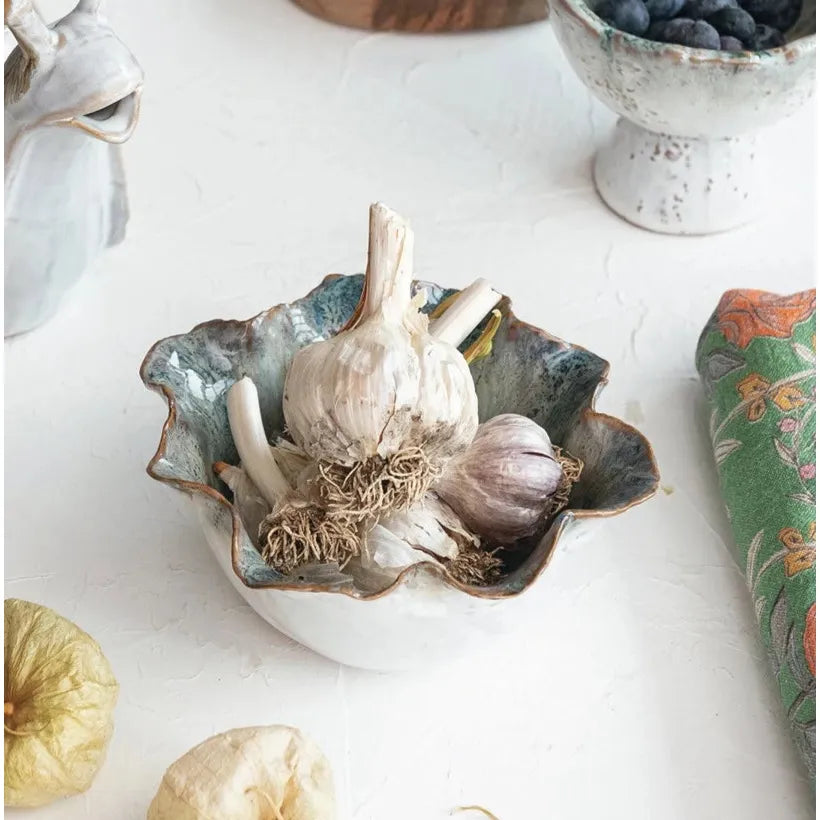 Assorted ceramic and wooden kitchen items on a white surface