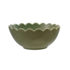 Three ceramic bowls in green, beige, and blue on a white background