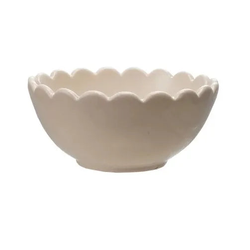Three ceramic bowls in green, beige, and blue on a white background