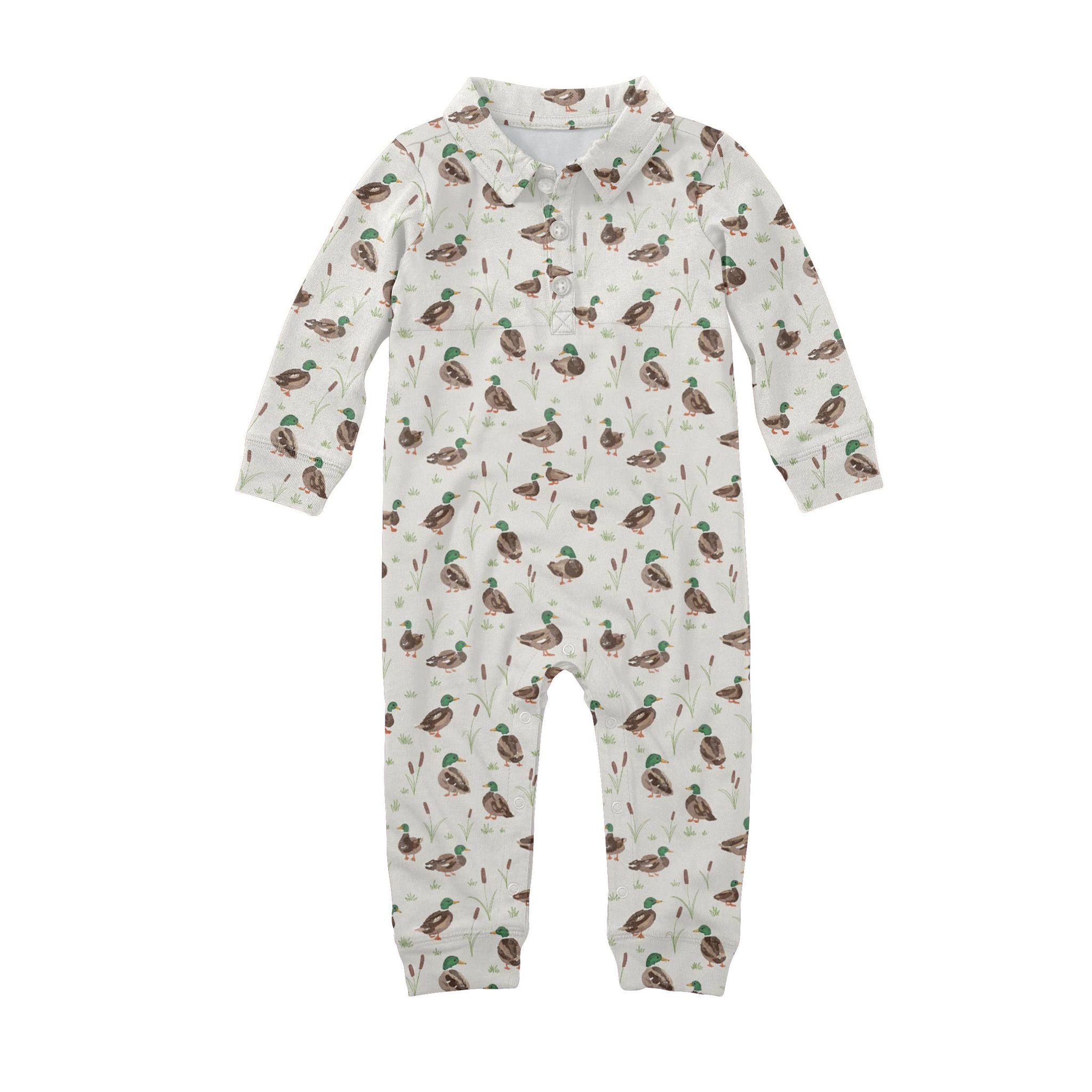 A baby long-sleeve footless one-piece jumpsuit in off-white, featuring an all-over print of mallards and reeds. The jumpsuit has a mock neck collar and a short snap-button placket at the chest.