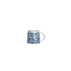 White mug with blue floral pattern on a white background